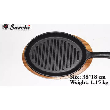cast iron skillet sizzling plate with vegetable oil coating fajita pan